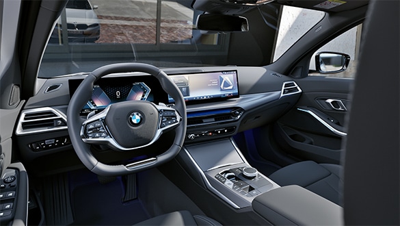 Cockpit des BMW 3er Touring mit schwarzen Sitzen und BMW Curved Display