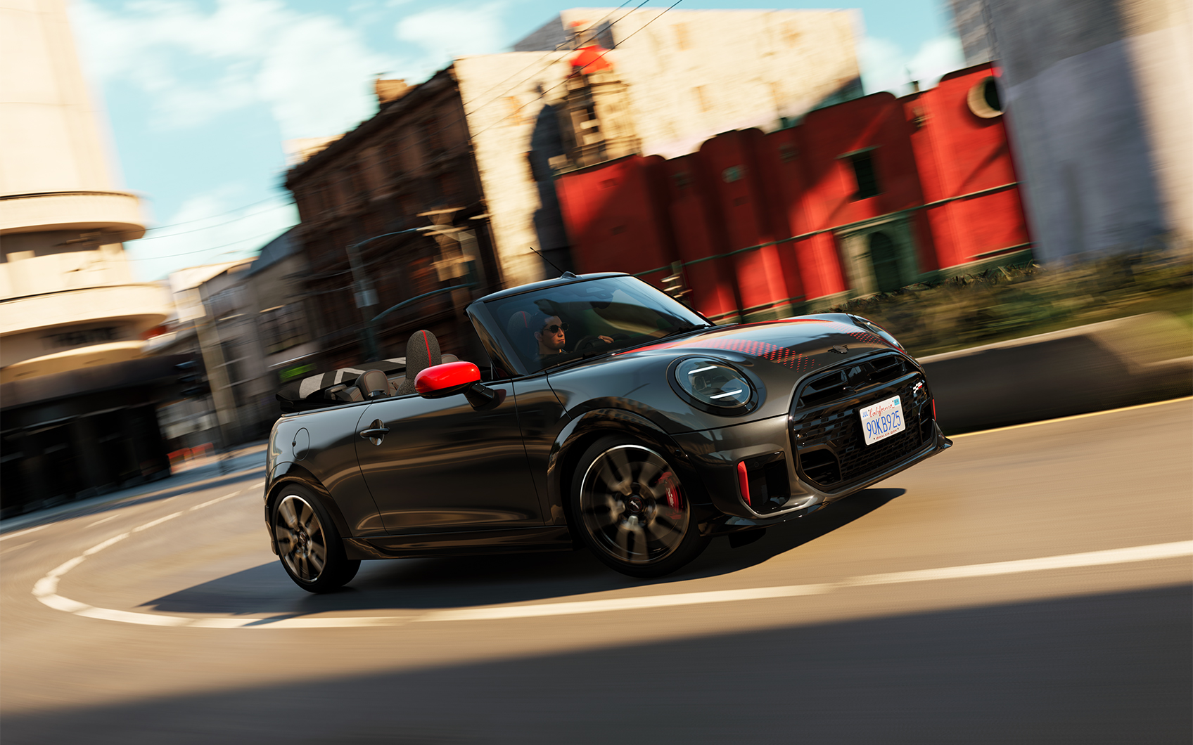 Seitenansicht eines MINI John Cooper Works Cabrio in der Farbe Schwarz mit roten Sport Stripes und Spiegelkappen in Fahrt mit geöffnetem Dach im städtischen Raum
