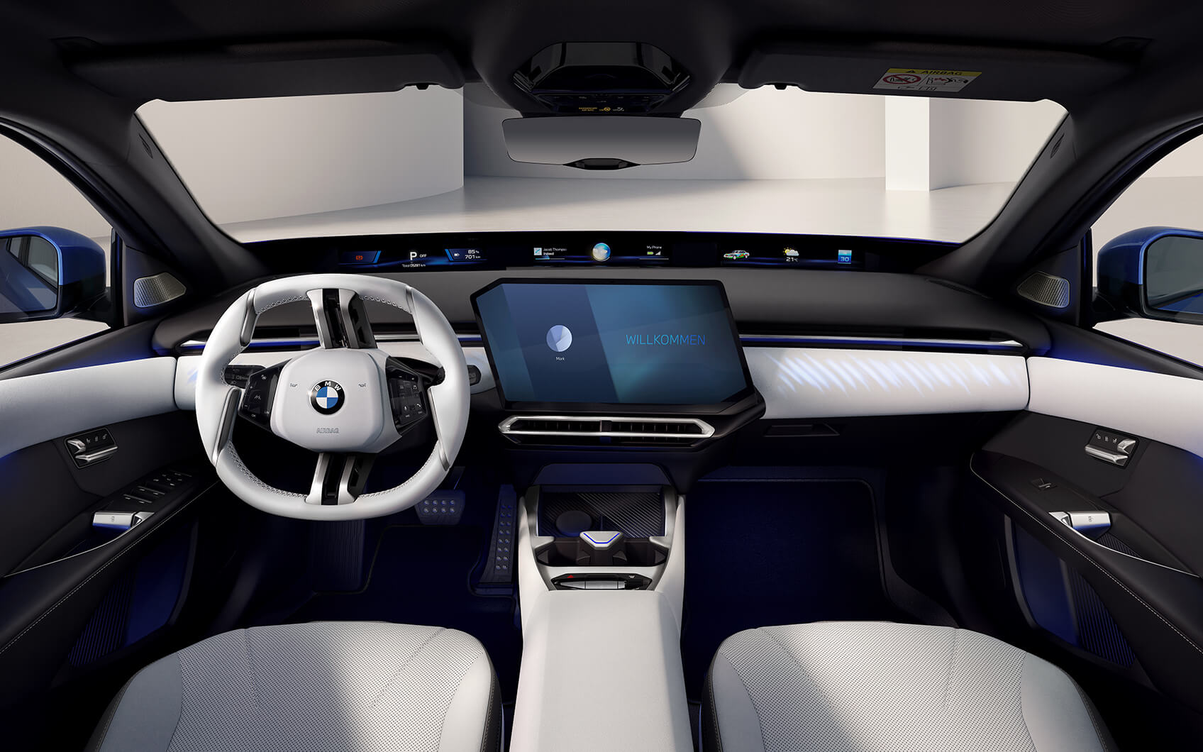 Innenraum der BMW i3 Limousine mit weißem Lenkrad, Panoramadisplay und zentralem Touchscreen
